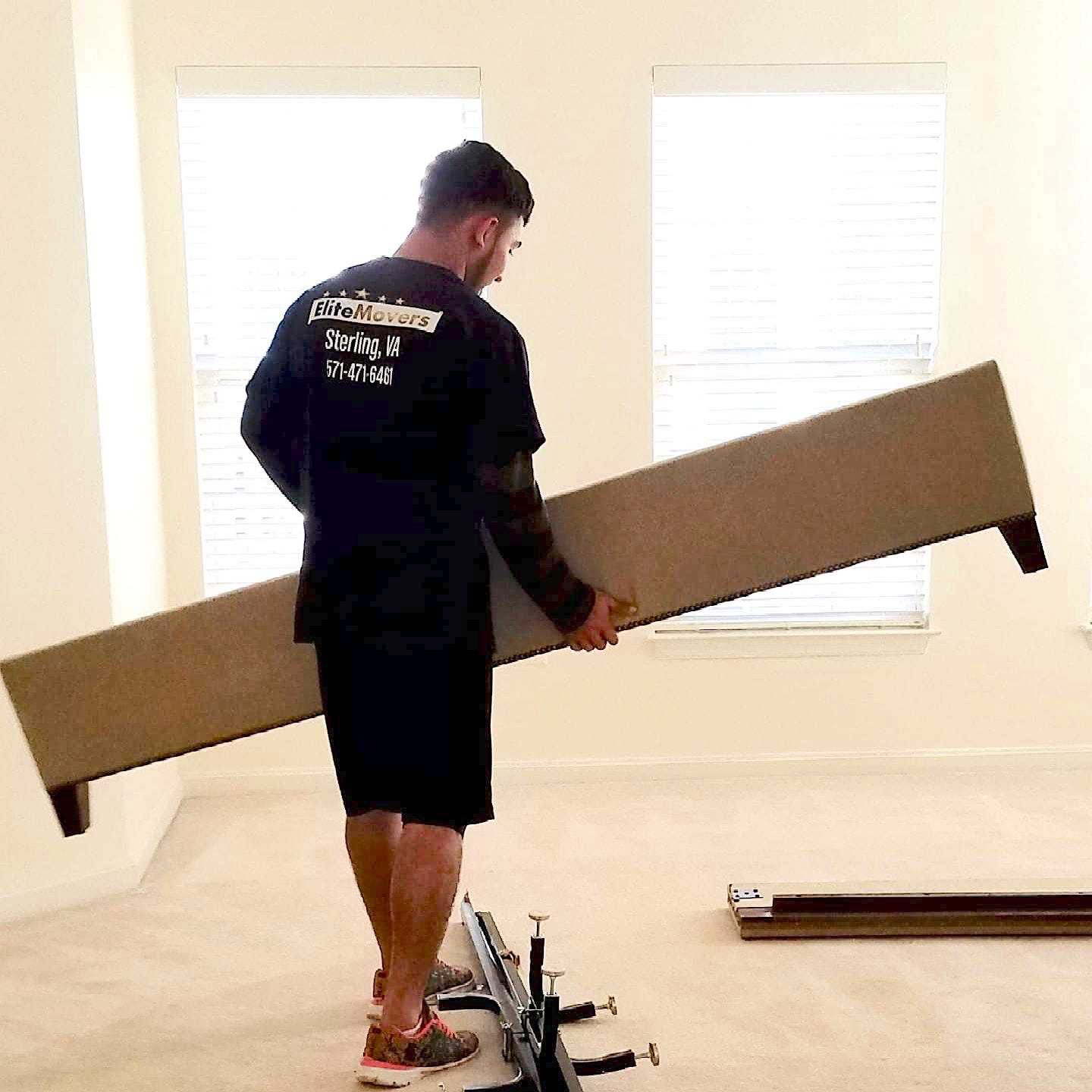 A employee is holding a bed frame