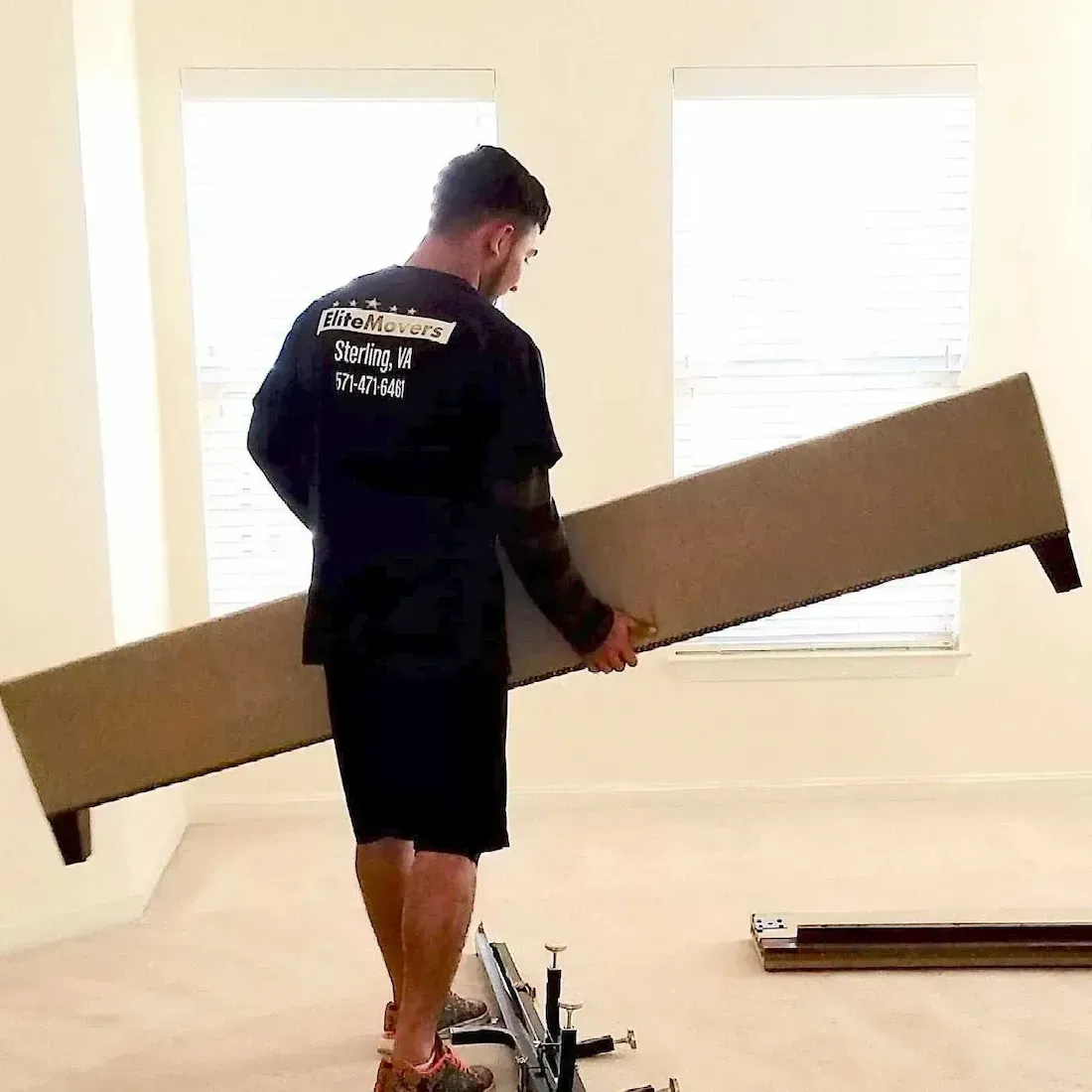 an employee holding a bed frame