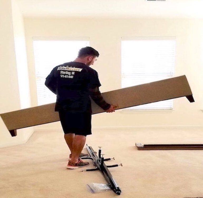 Movers lifting a wooden chair