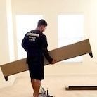 a employee is holding a bed frame