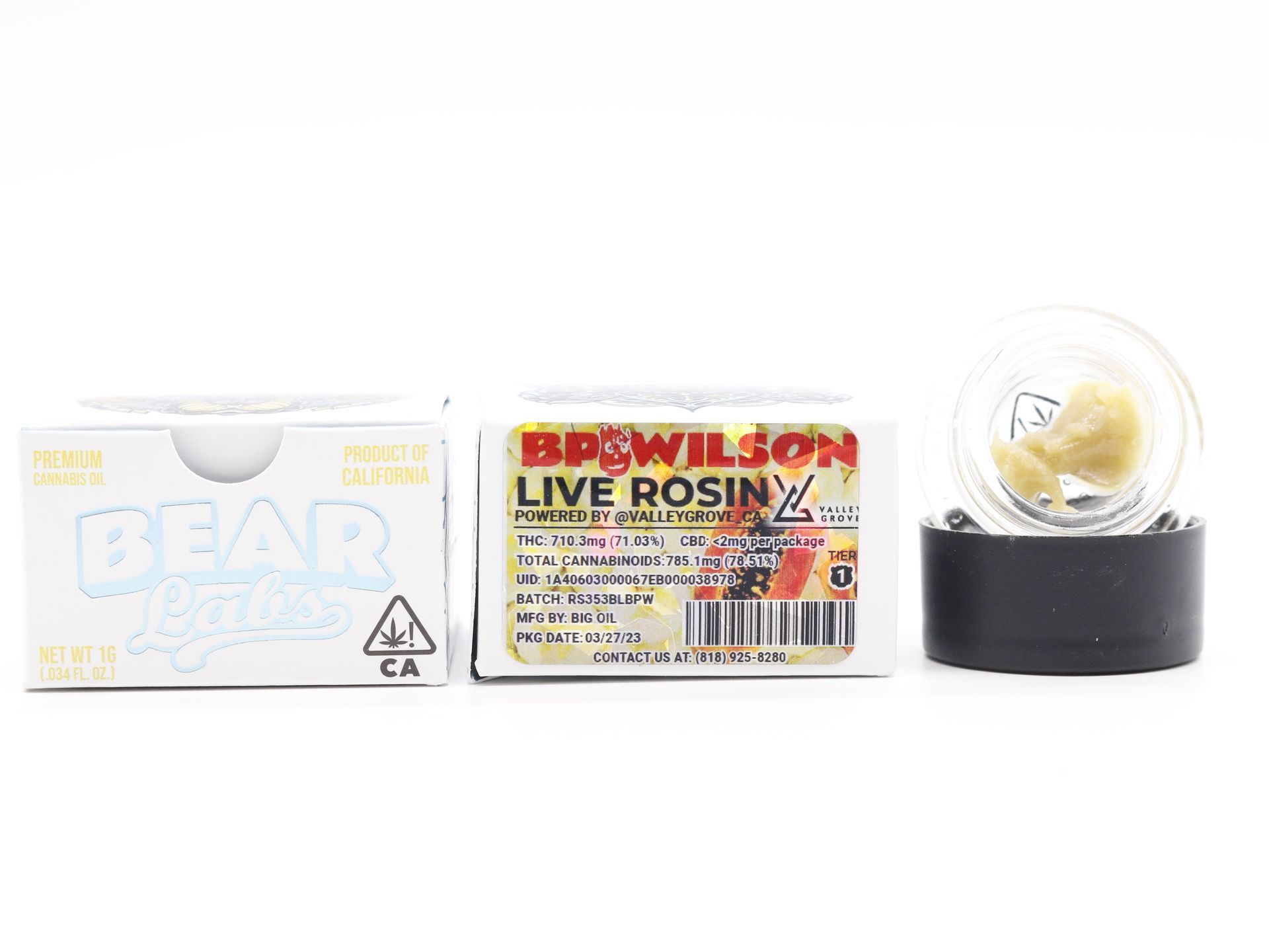 A box of live rosin next to a glass ball.
