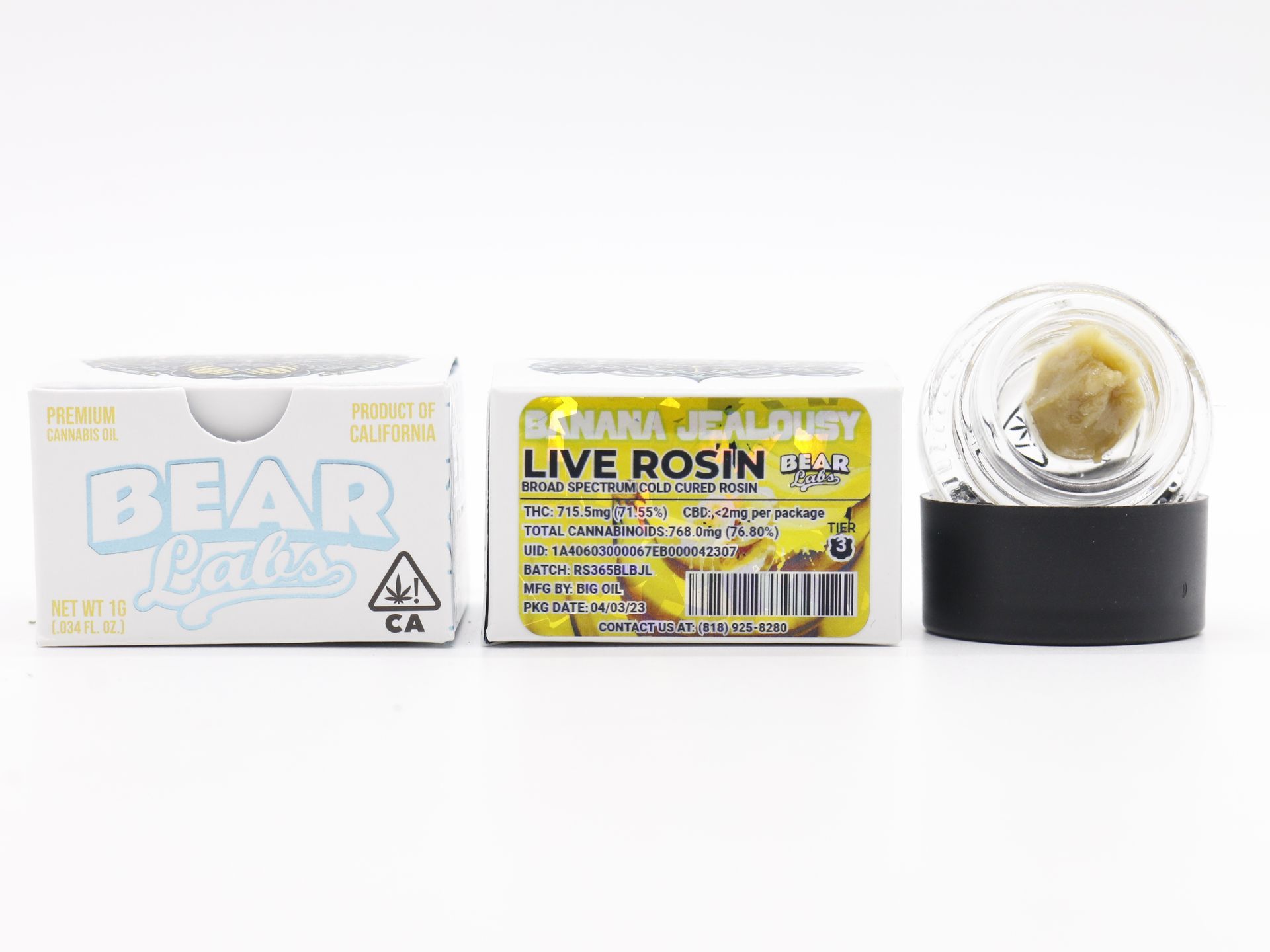 There is a jar of live rosin next to a box of live rosin.