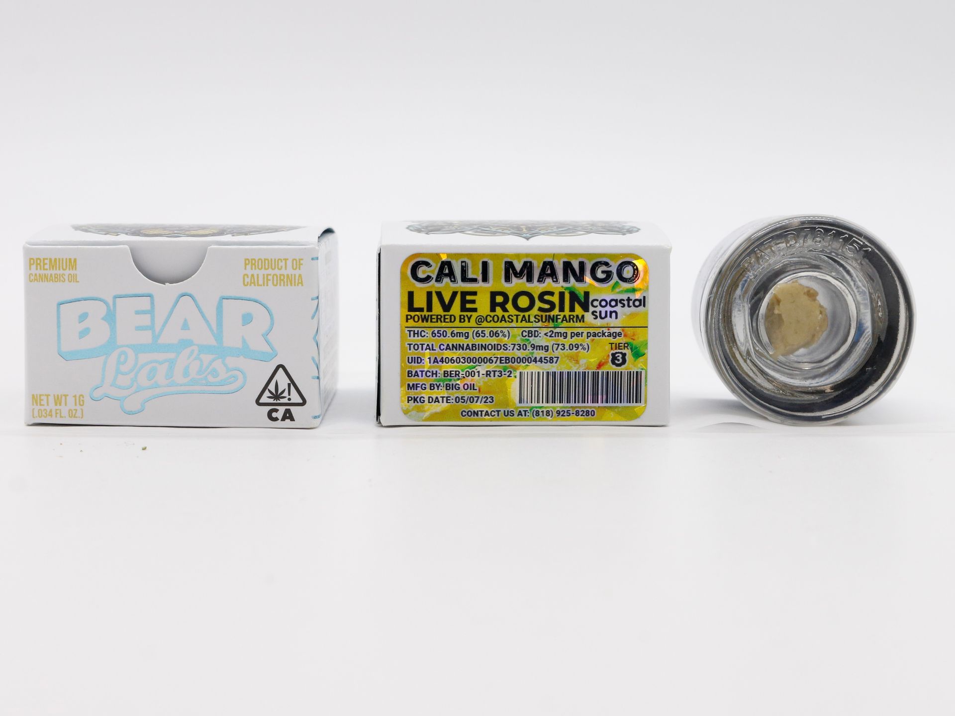 A box of cali mango live rosin next to a jar of it.