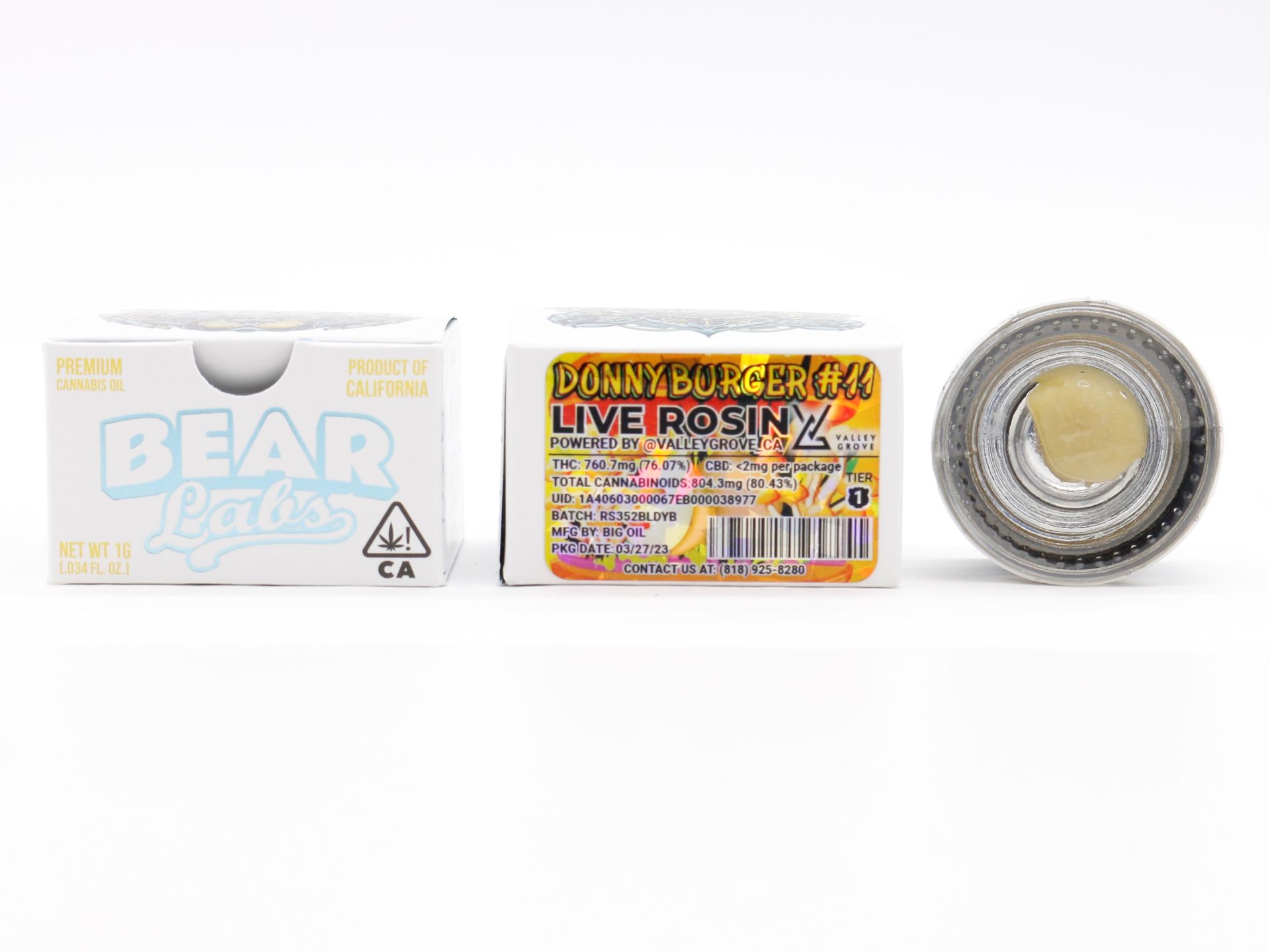 A box of live rosin next to a container of live rosin.
