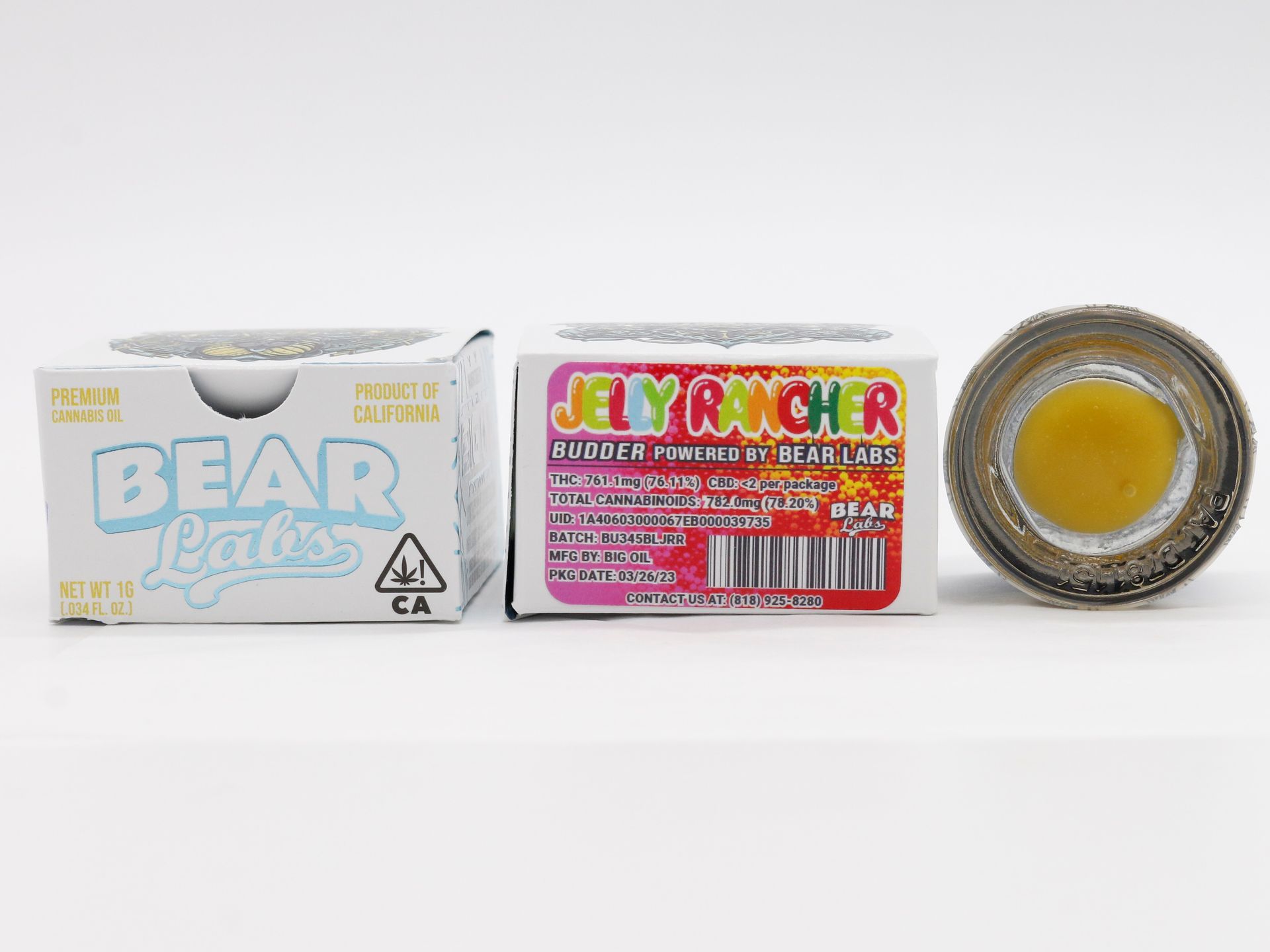 A jar of jelly and a box of jelly are sitting next to each other on a white surface.