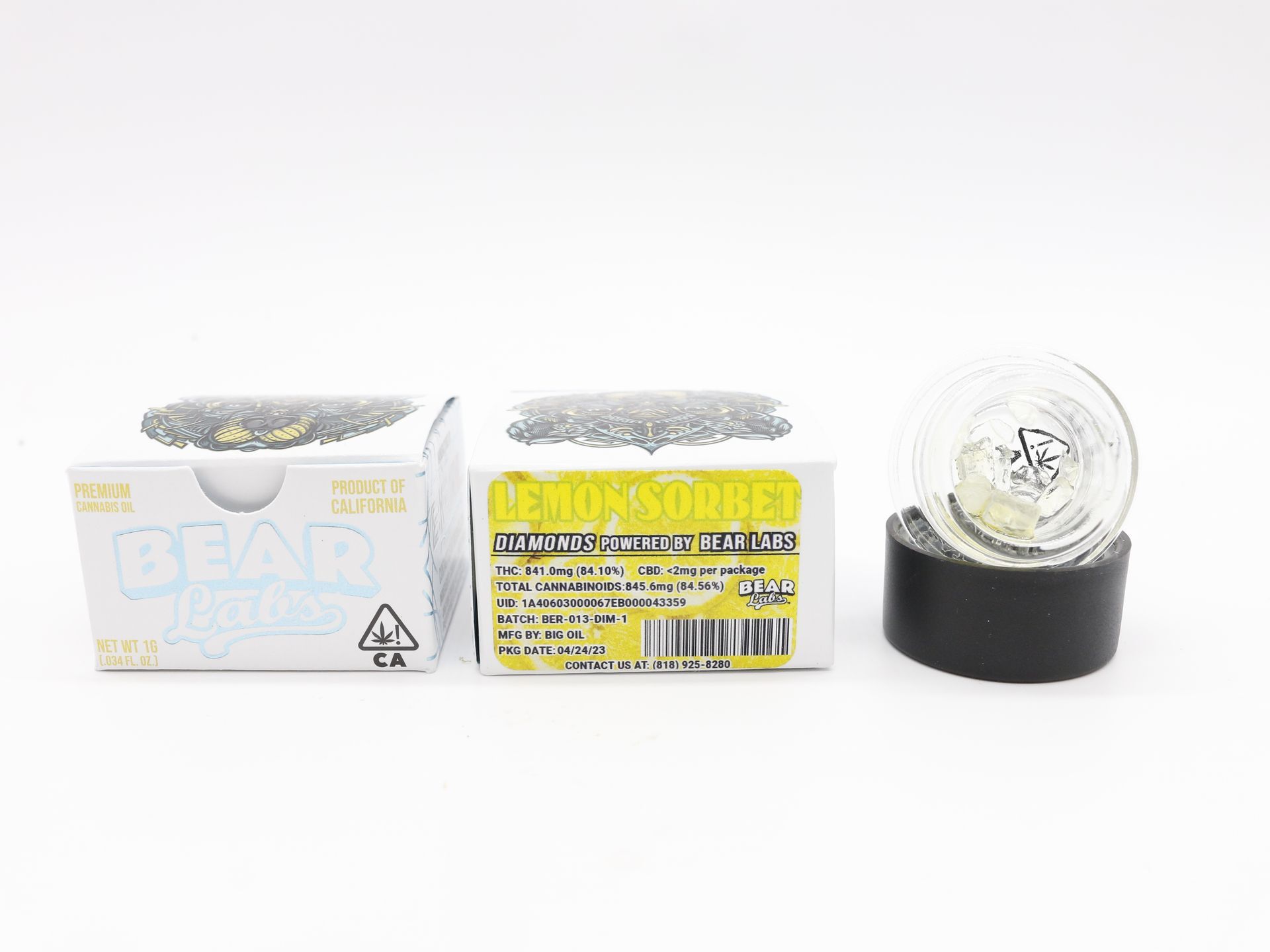 A snow globe is sitting next to a box of pearls.