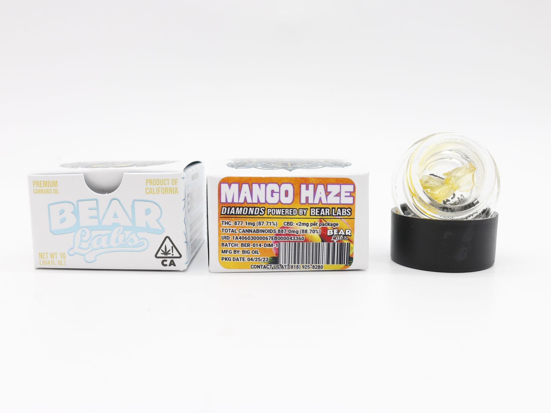 A box of mango haze next to a glass jar.