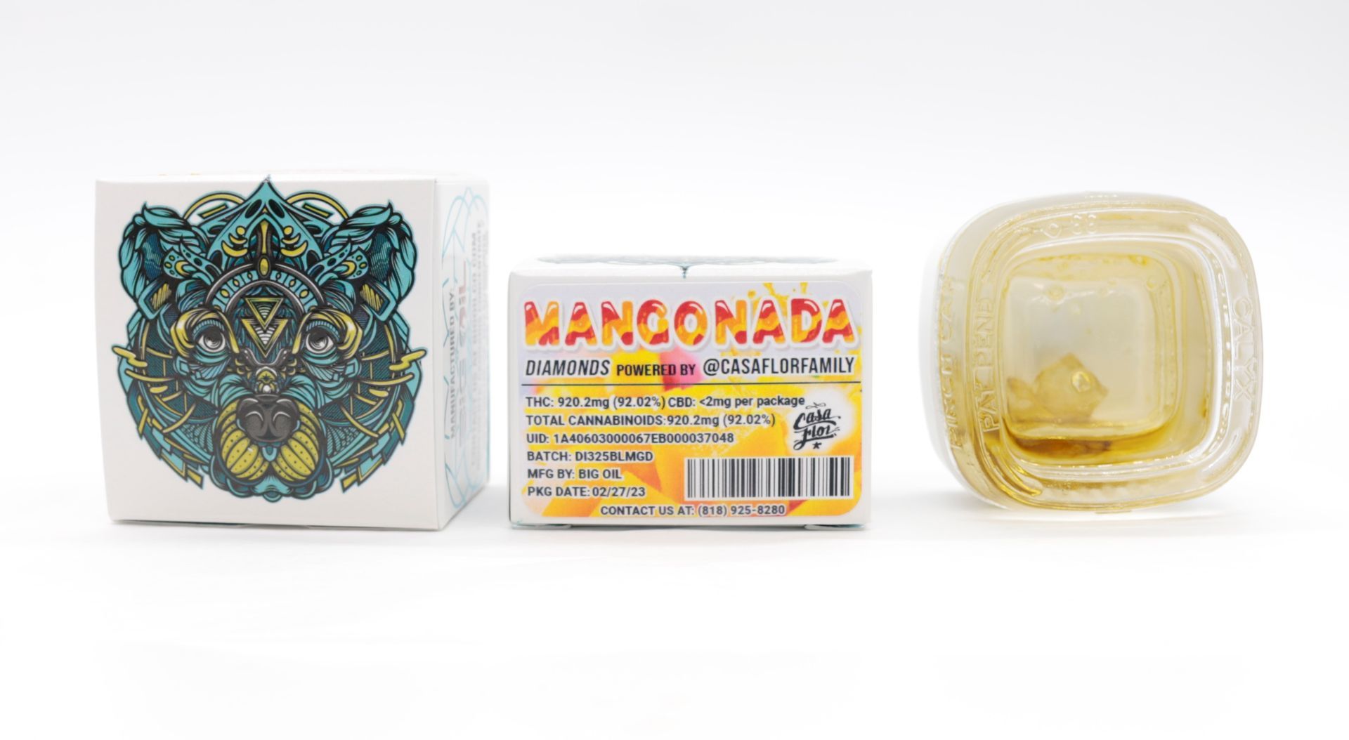A box of mangonada next to a container of mangonada on a white surface.