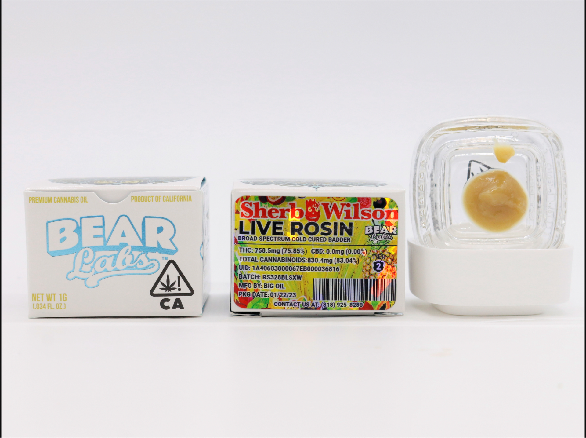 A box of bear balls and a box of sherb wilson live rosin are sitting next to each other on a table.