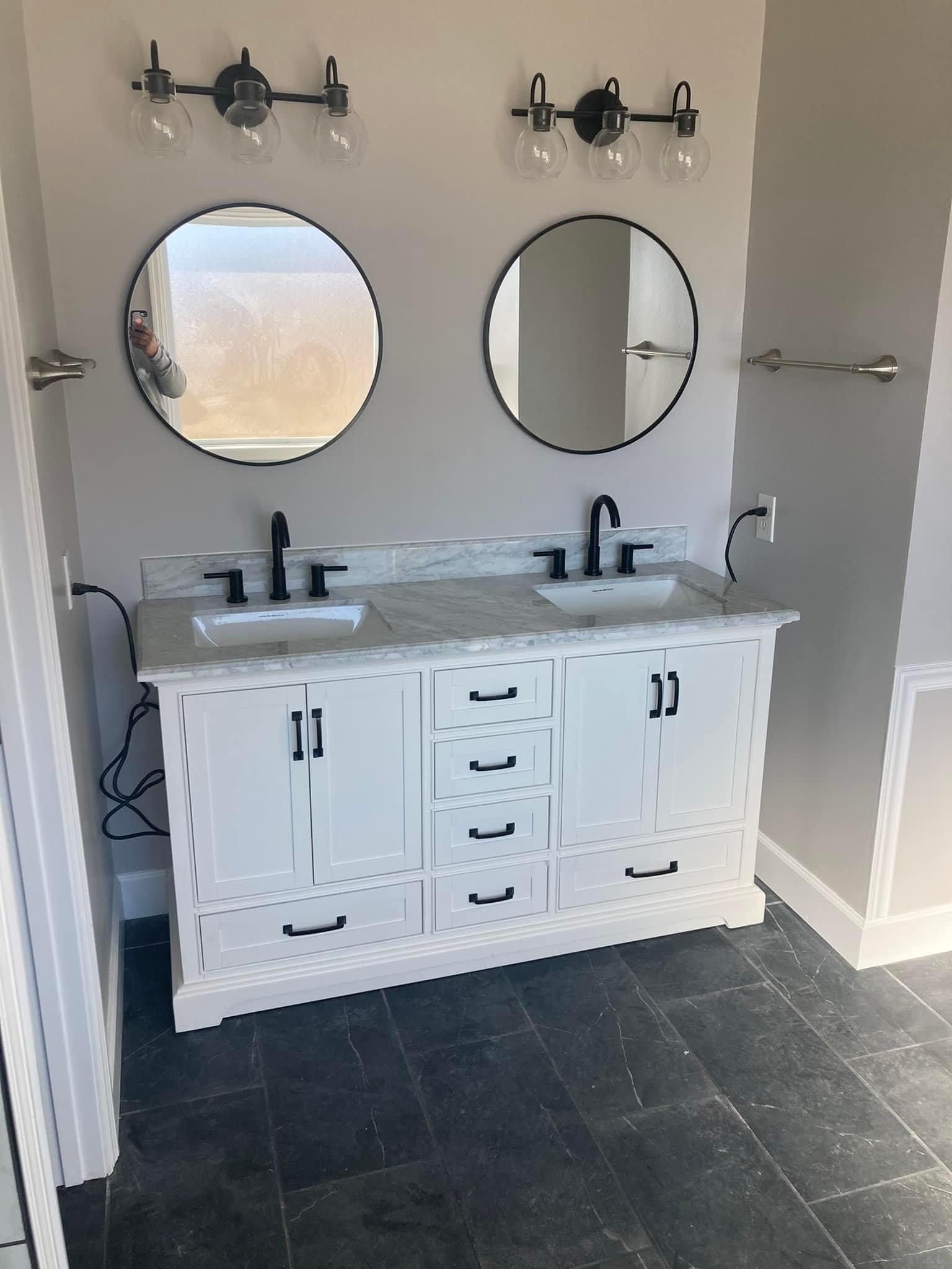 A bathroom with two sinks and two mirrors.