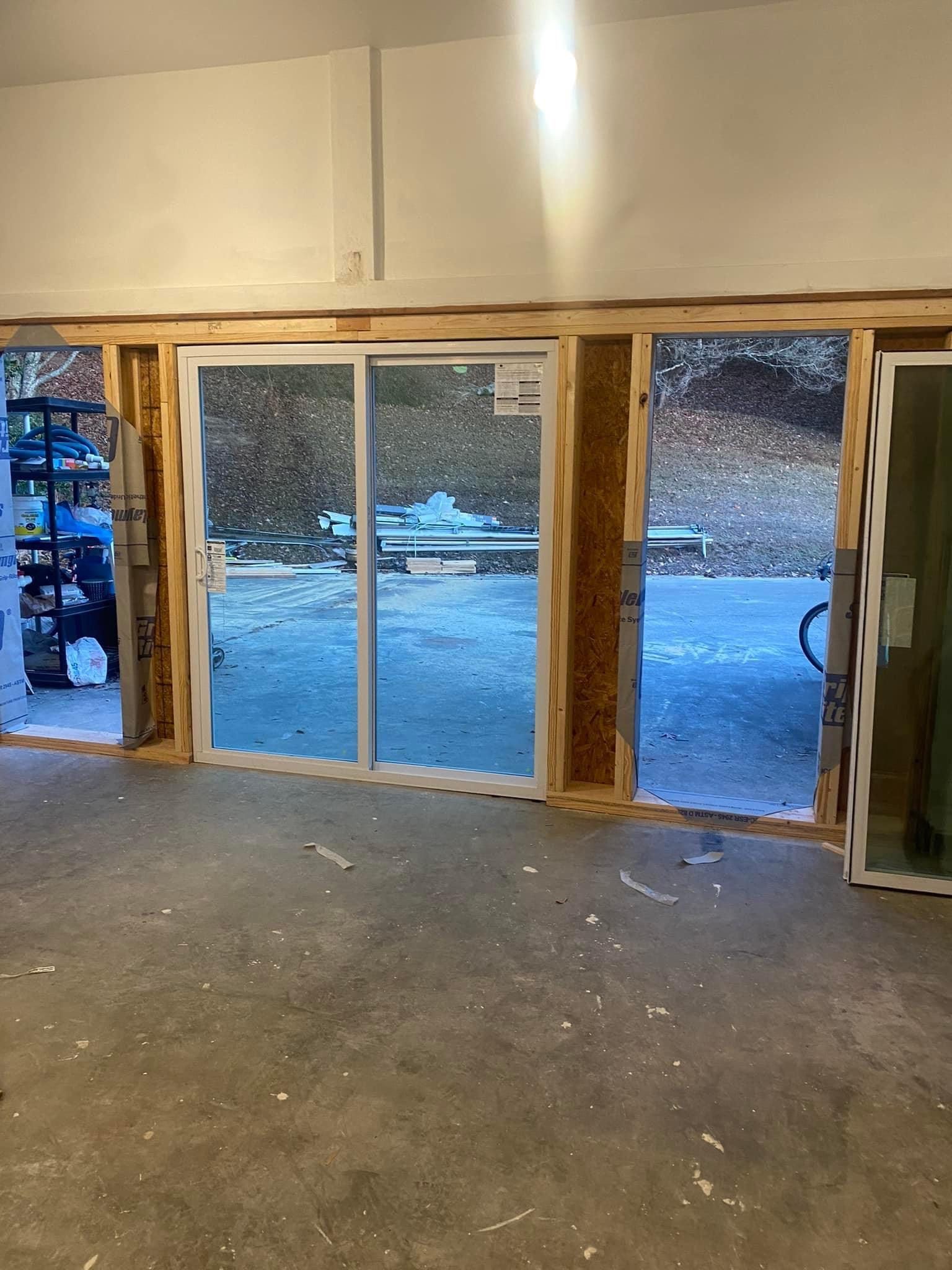 A room with a lot of windows and a sliding glass door.