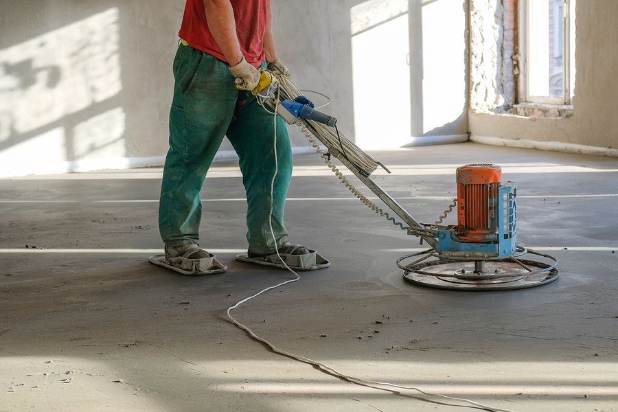 A man preparing a concrete garage floor