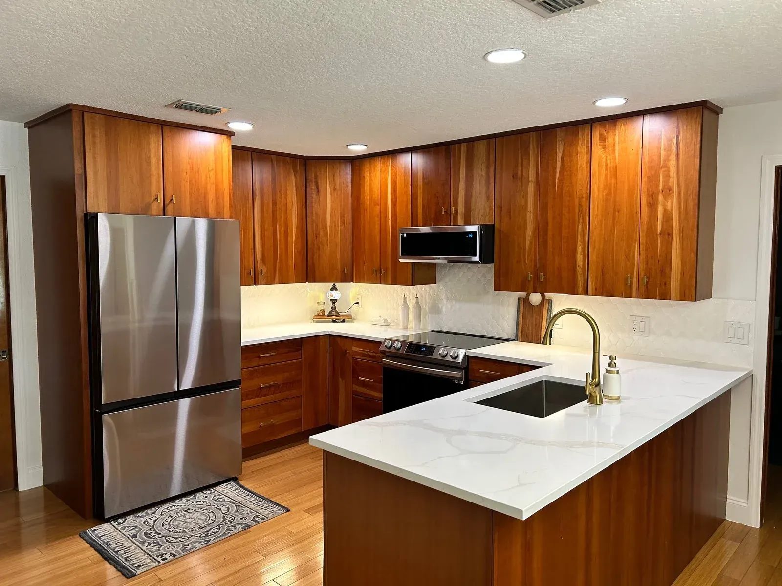A kitchen with wooden cabinets and stainless steel appliances