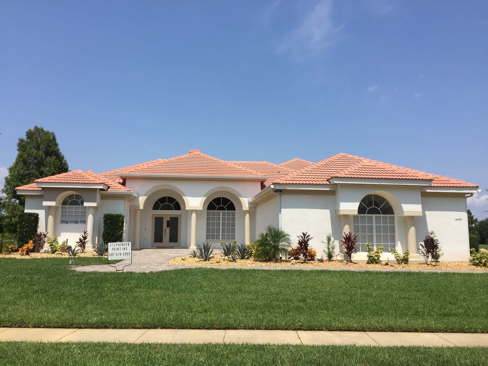 A large white house with a red tile roof