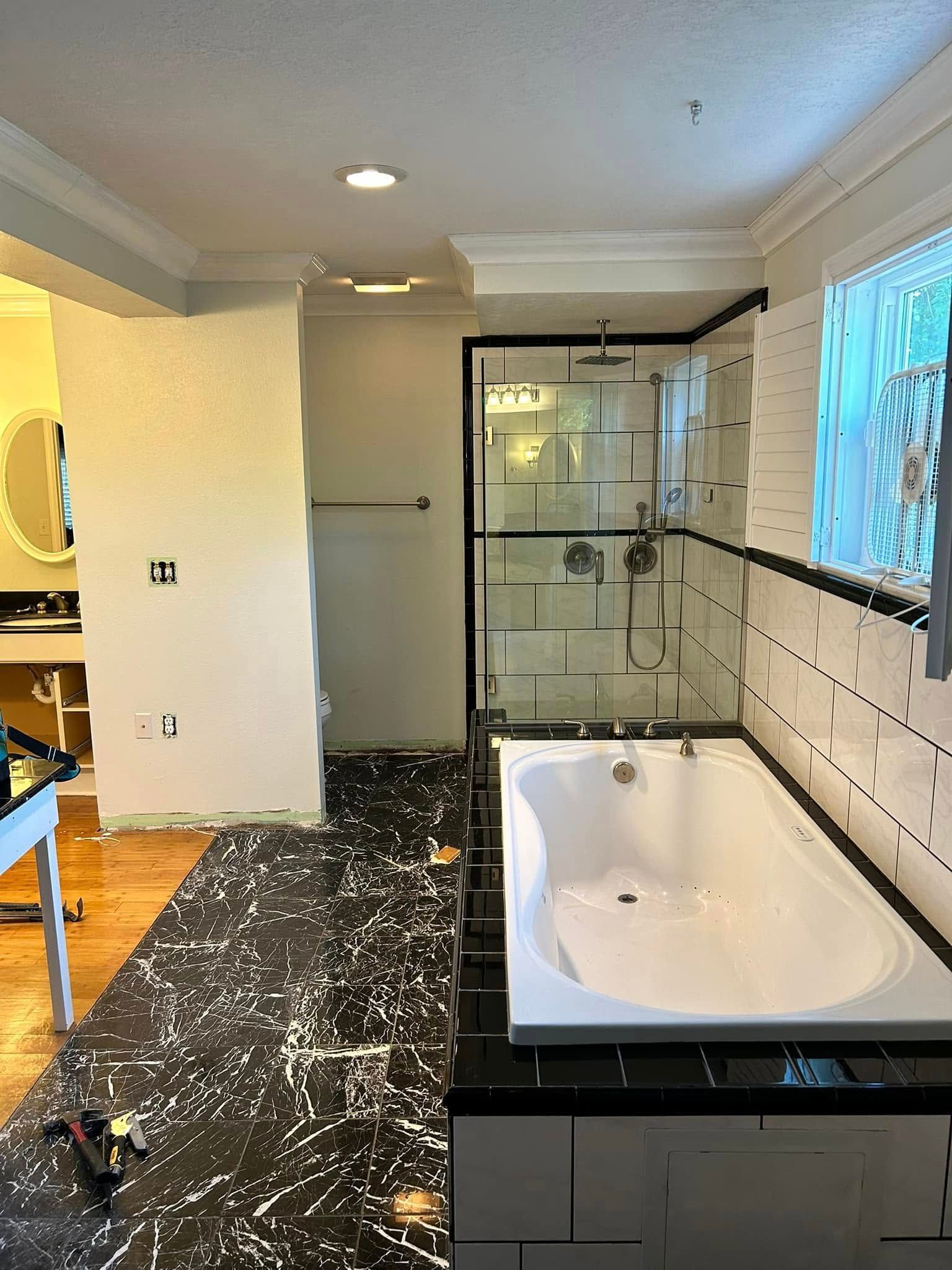 A bathroom with a bathtub and a shower.