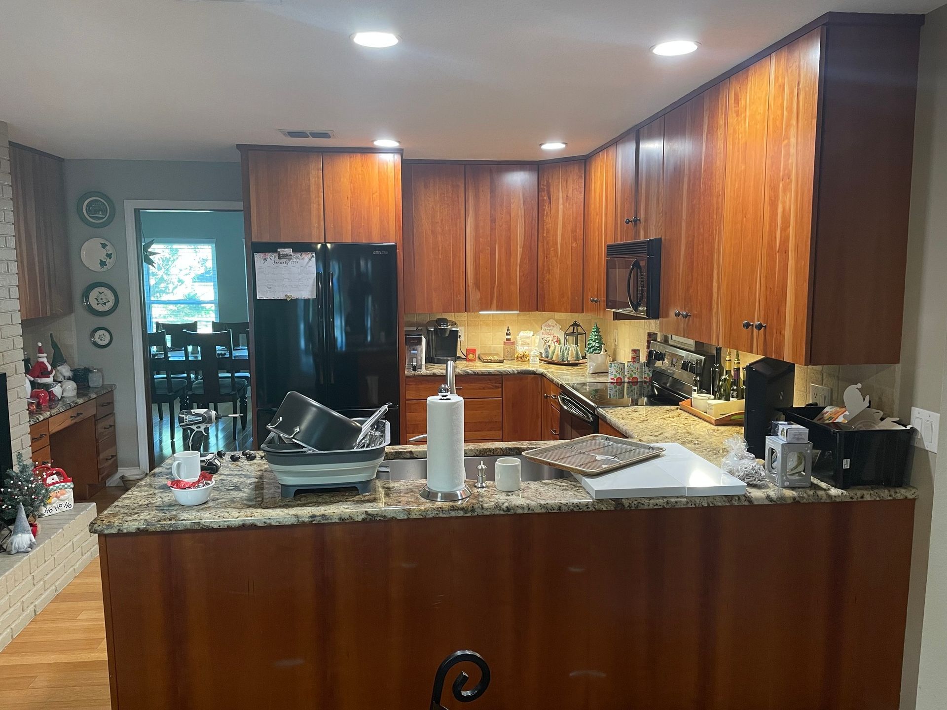 A kitchen with wooden cabinets and granite counter tops.