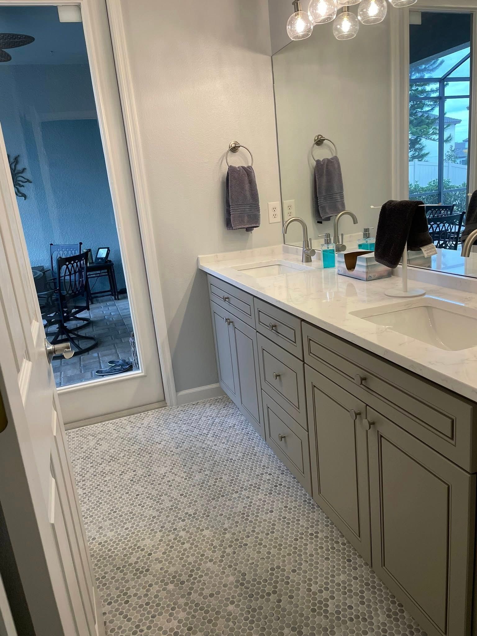 A bathroom with two sinks and a large mirror.