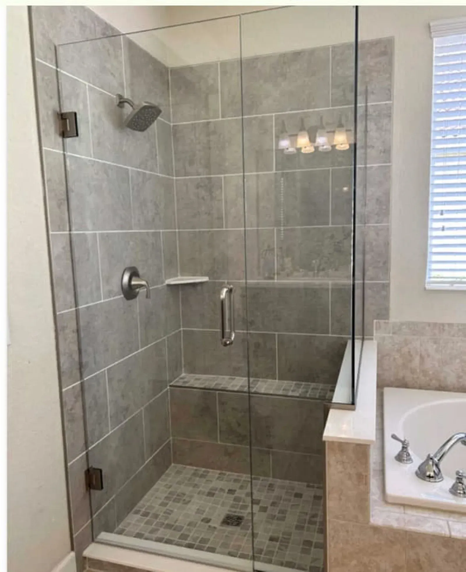 A bathroom with a walk in shower and a bathtub