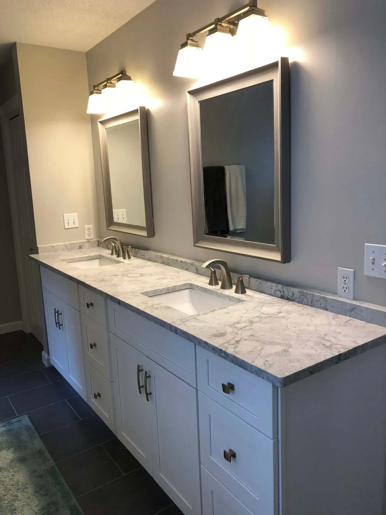 A bathroom with two sinks and two mirrors.