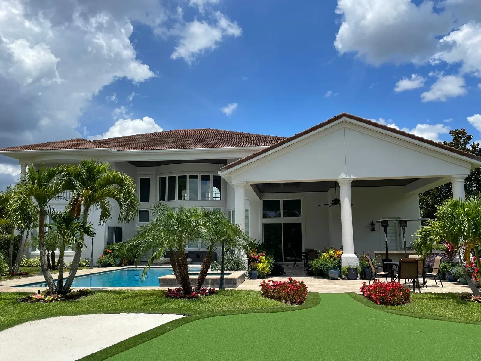 A large white house with a swimming pool in the backyard