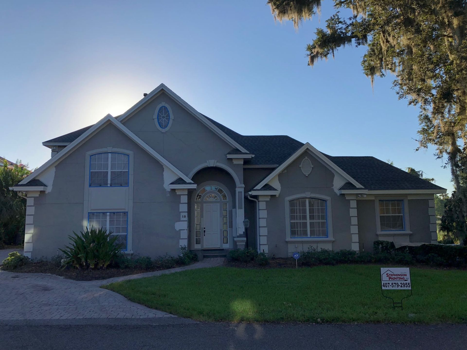 A large house with a for sale sign in front of it