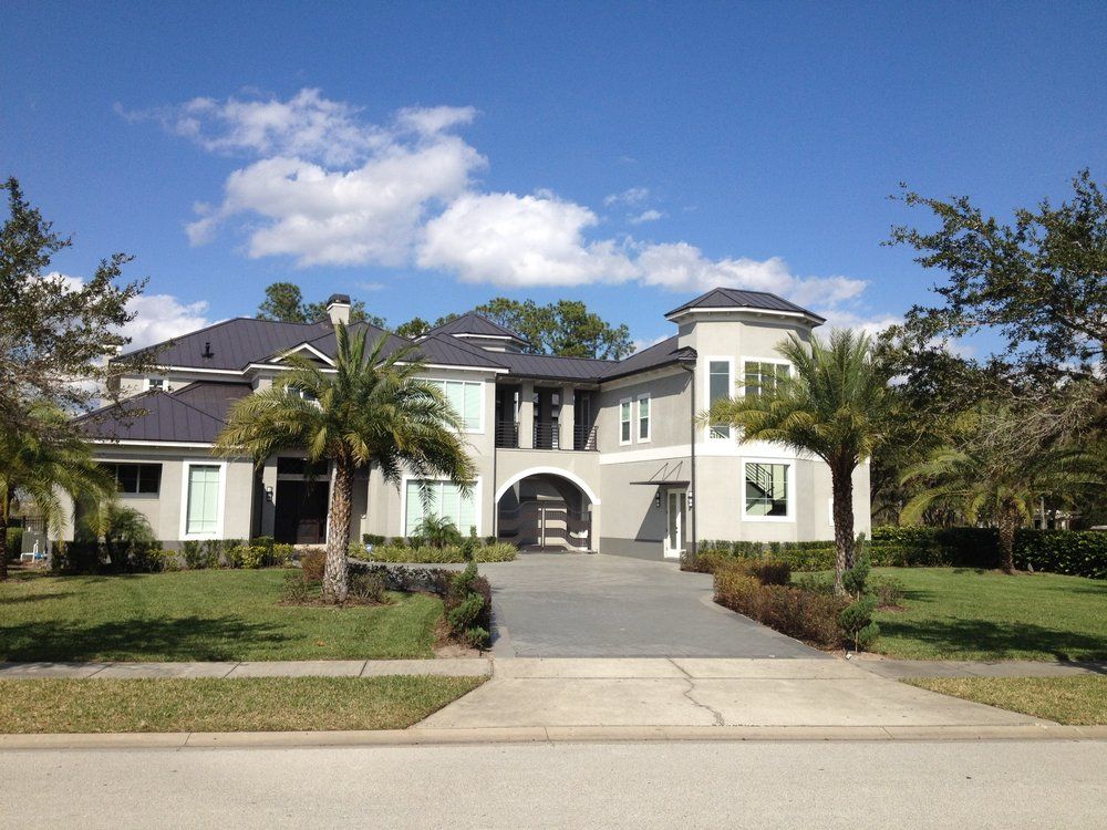 A large house with palm trees in front of it