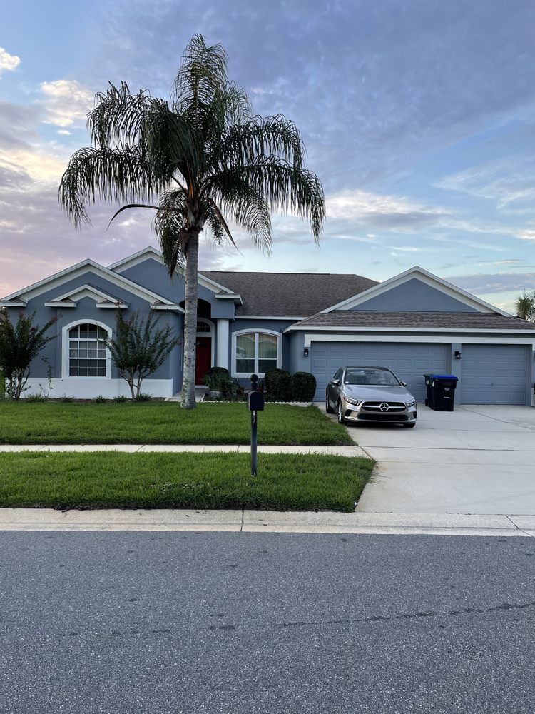 A trailer is parked in front of a yellow house