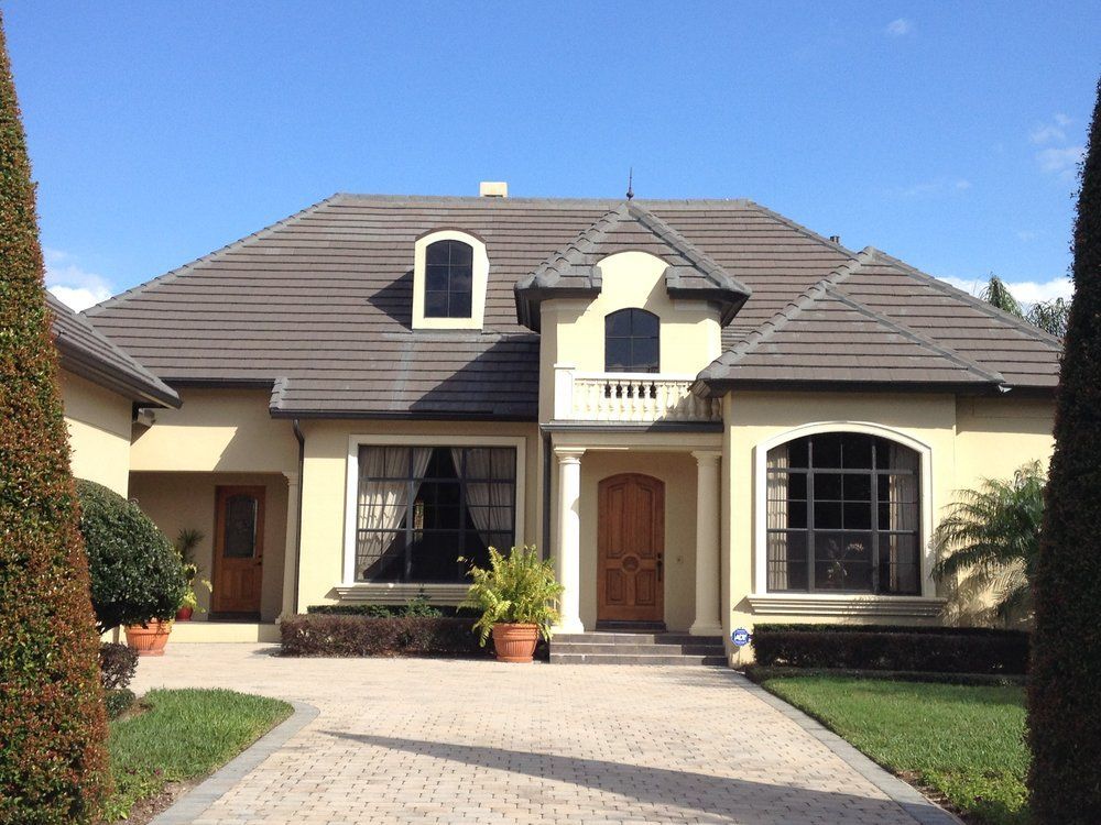 A large house with a brick driveway leading to it
