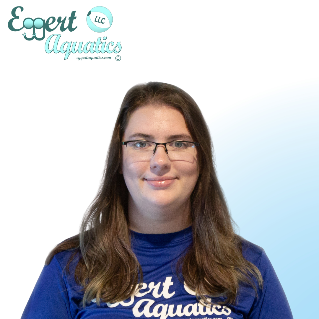 A woman wearing glasses and a blue shirt that says expert aquatics
