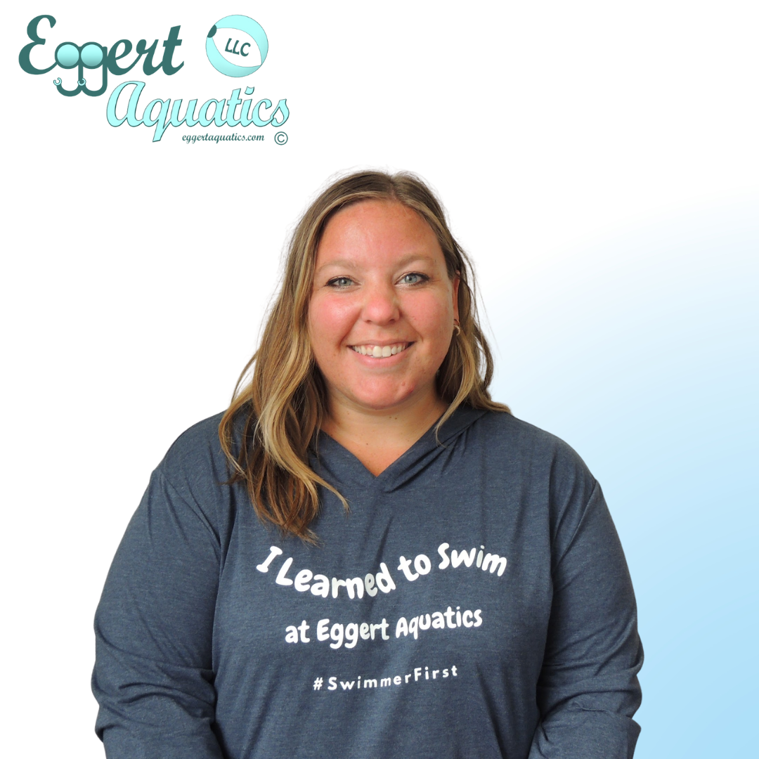 A woman wearing a shirt that says i learned to swim at eggert aquatics