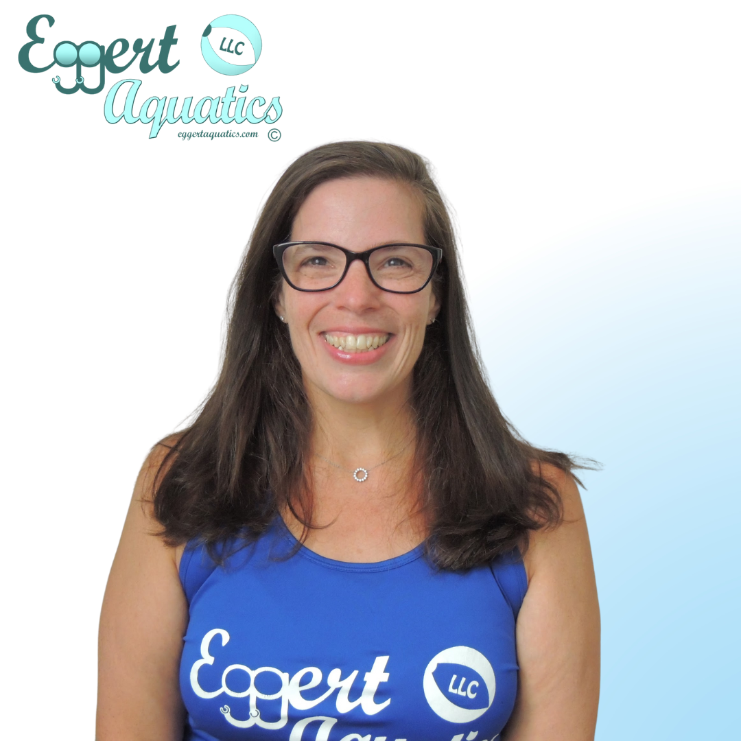 A woman wearing glasses and a blue shirt that says expert