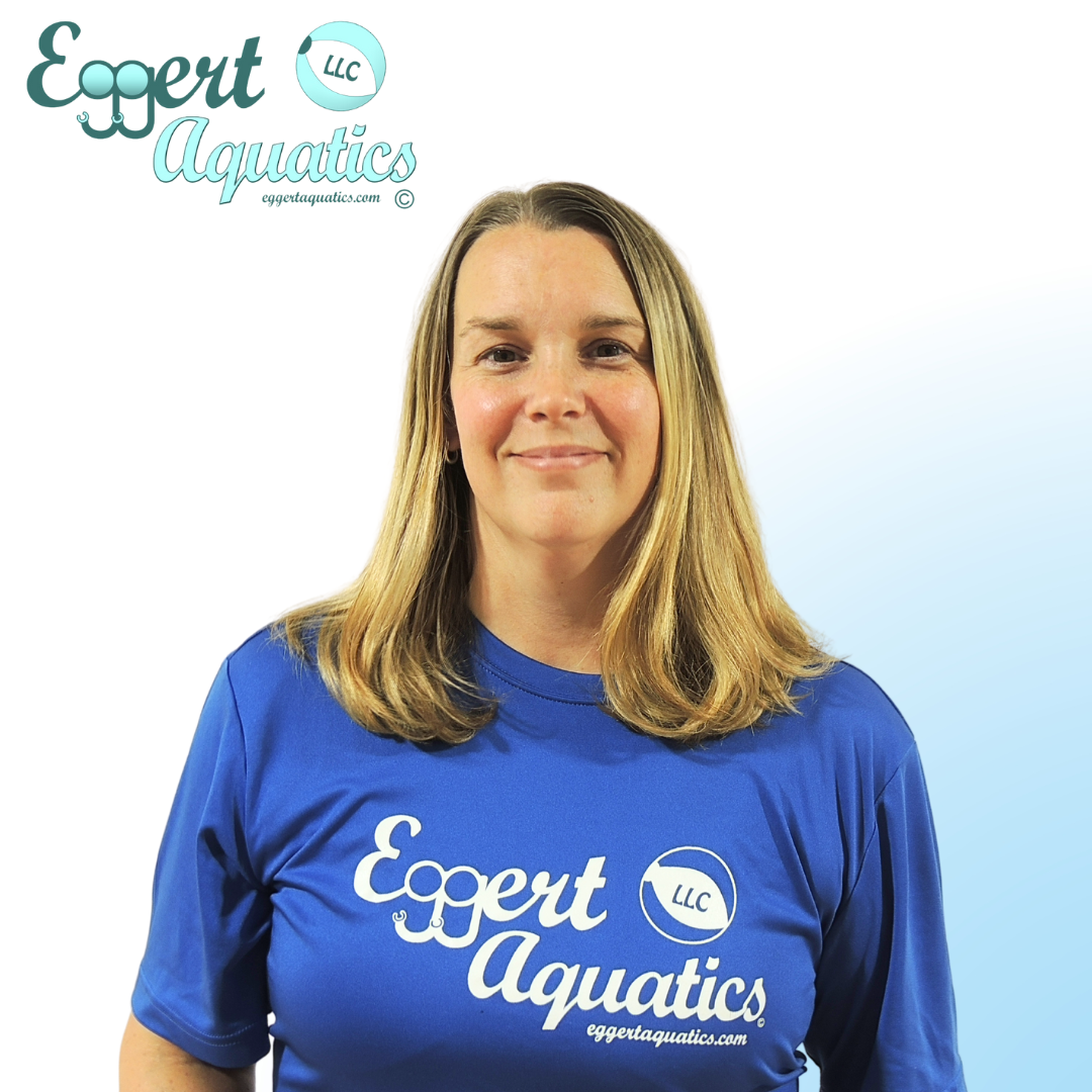 A woman wearing a blue shirt that says eggert aquatics