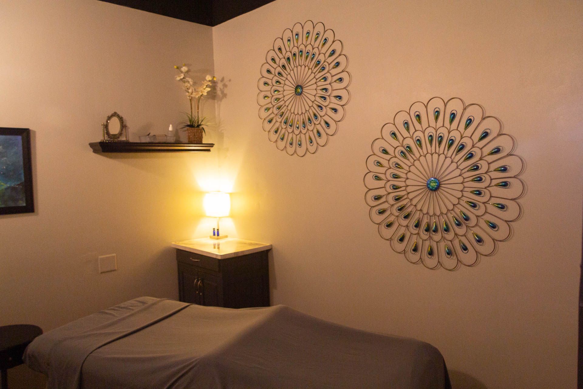 a massage table in a room with two circular decorations on the wall .