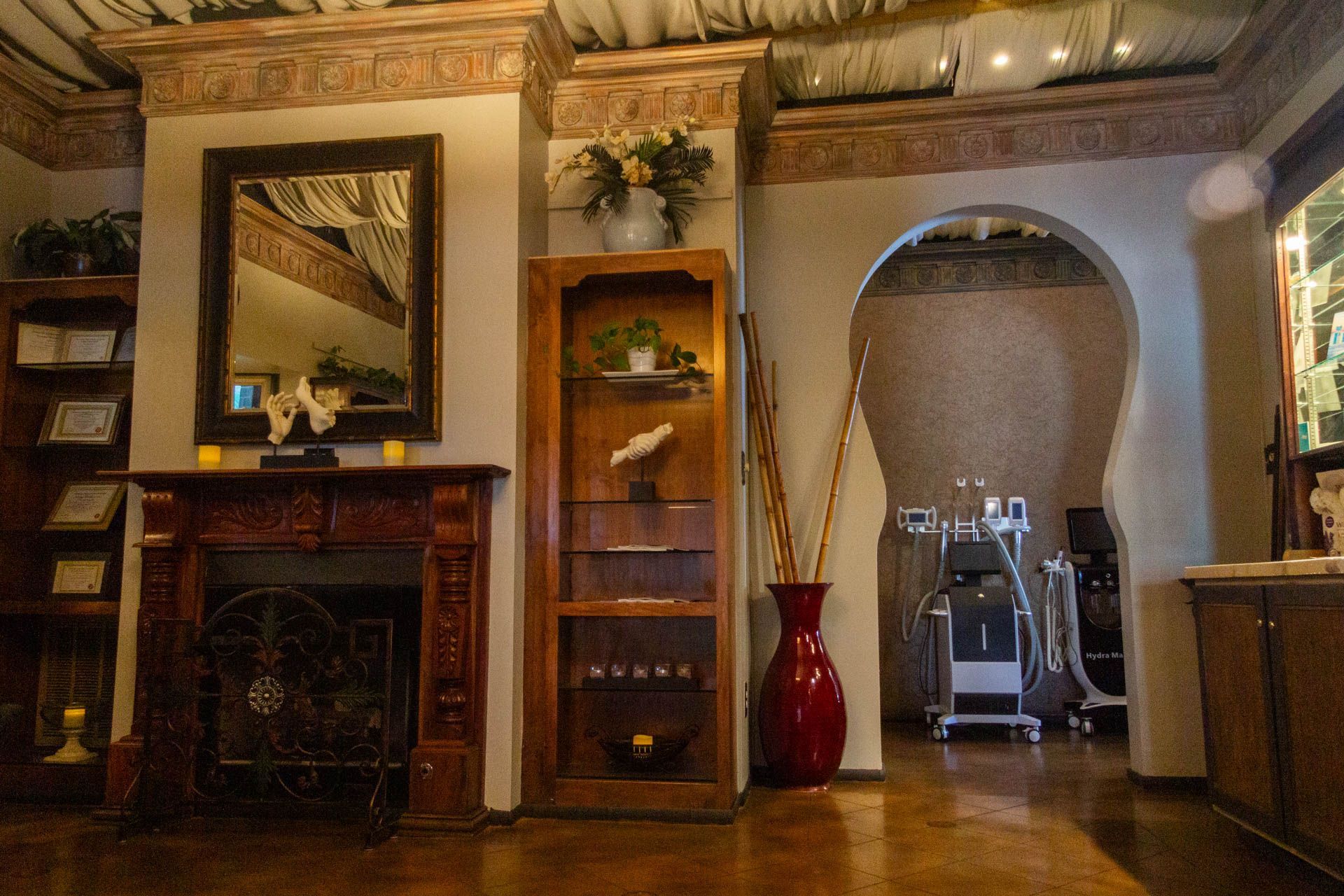a living room with a fireplace and a mirror