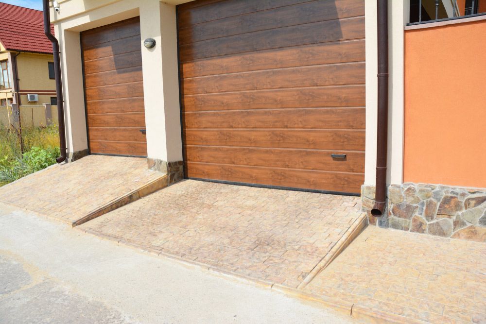 A Couple Of Garage Doors Are Sitting Next To Each Other On The Side Of A Building — Lighthouse Beach Garage Door Service in Port Macquarie, NSW