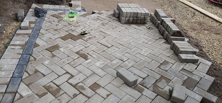 Installation of pavers in a backyard patio