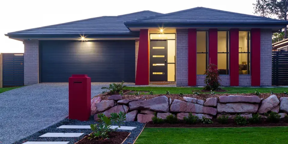 A house with a red mailbox in front of it.