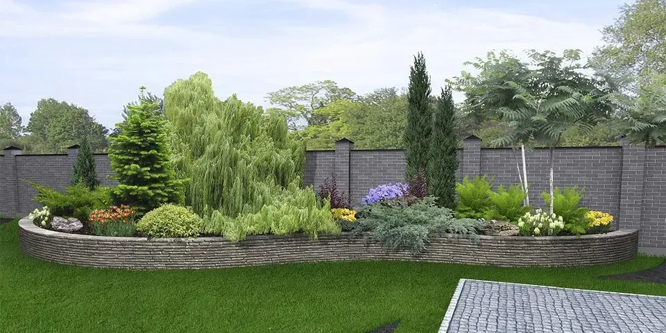 A garden with a brick wall surrounded by trees and flowers.