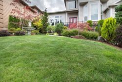 A large house with a lush green lawn in front of it.