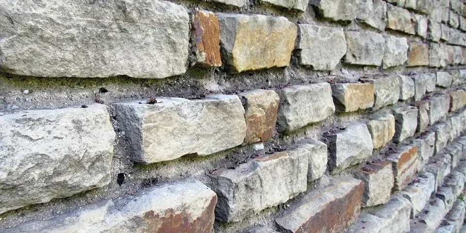 A close up of a brick wall with a lot of bricks.