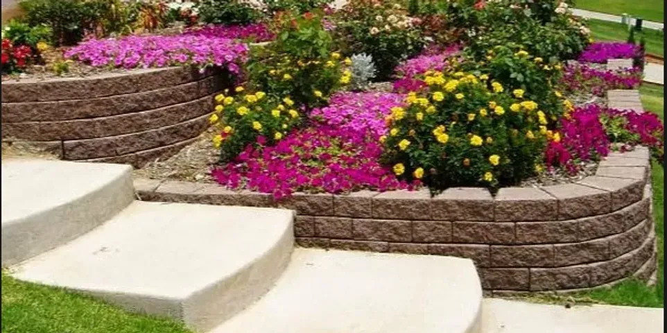 A garden with flowers and stairs leading up to it