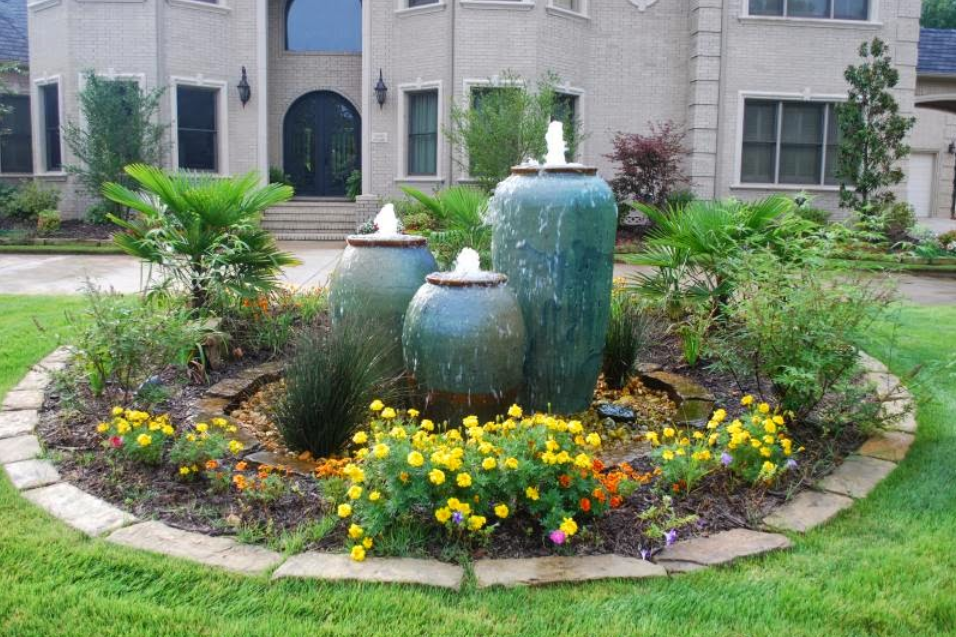 A large house with a fountain in front of it