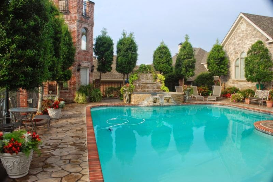 A large swimming pool in the backyard of a house