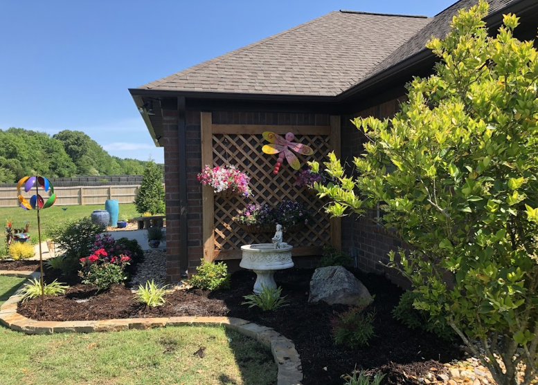 A house with a bird bath in front of it