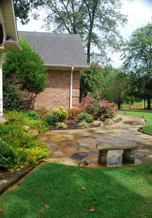 A brick house with a stone walkway leading to it