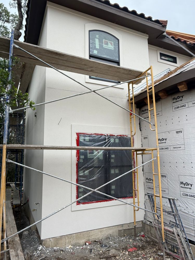House exterior under construction with scaffolding and covered windows