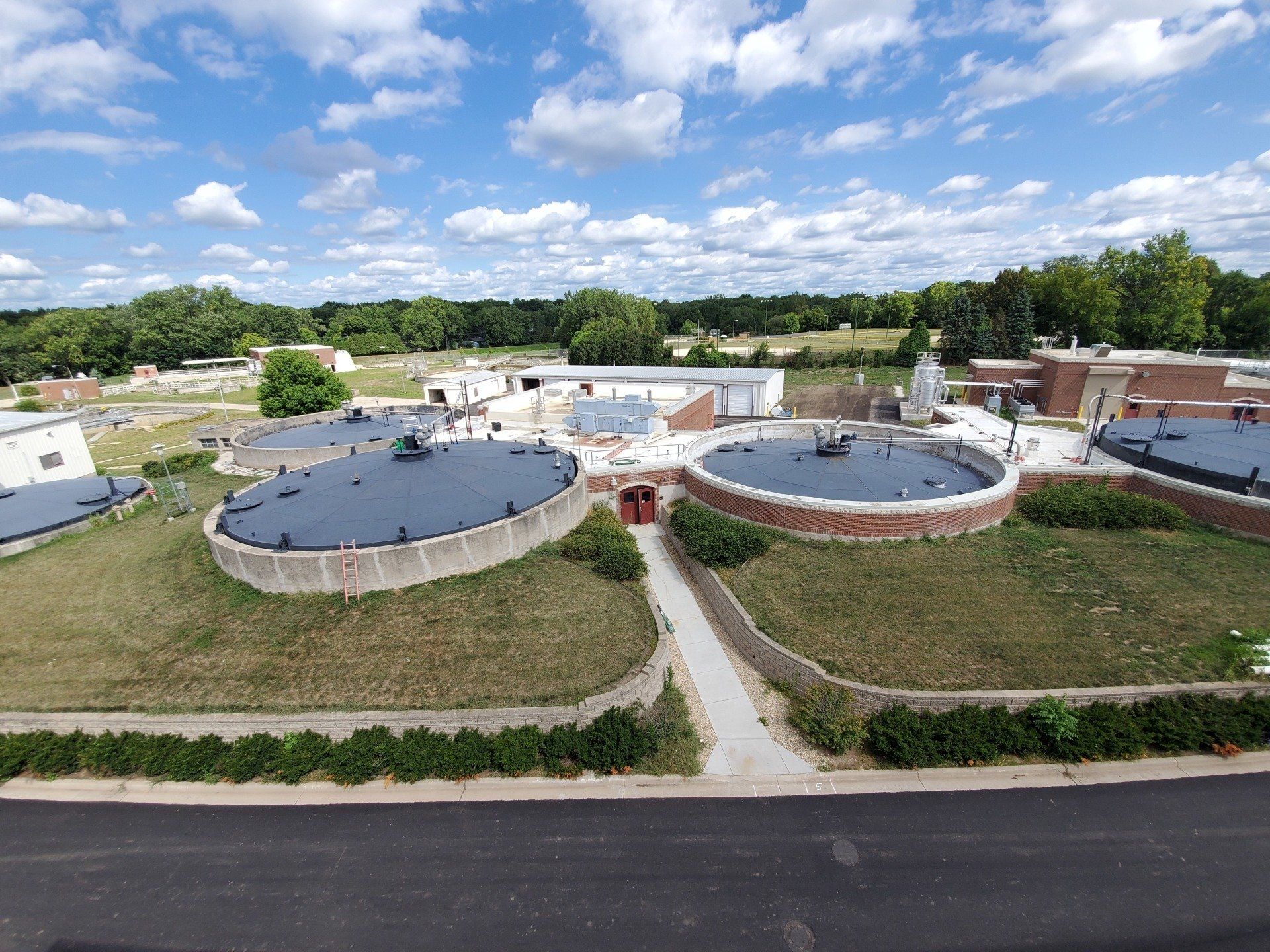 An aerial view of a sewage treatment plant on a sunny day.