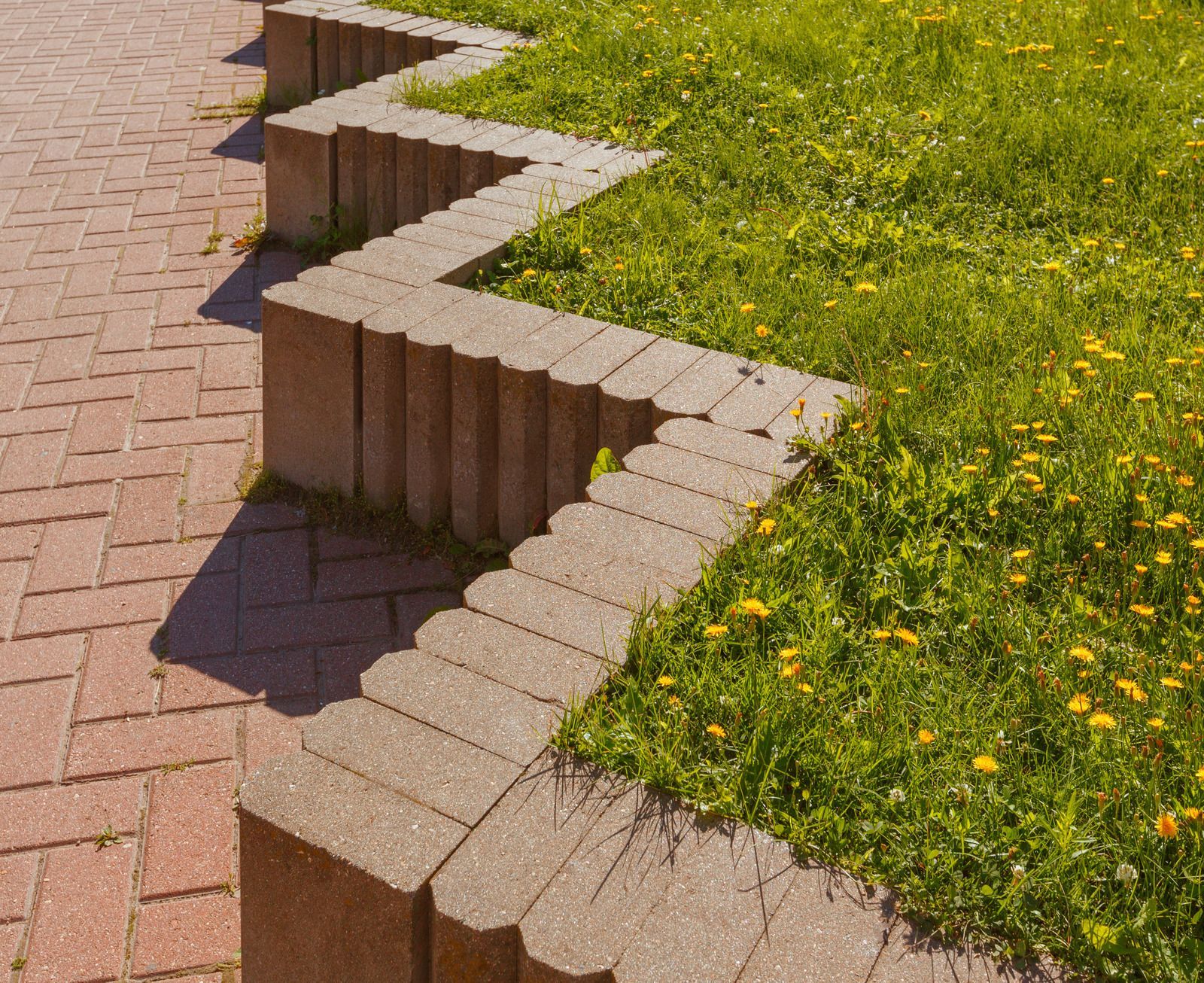 HVAC technician repairs an air conditioning unit on a rooftop, using a drill.