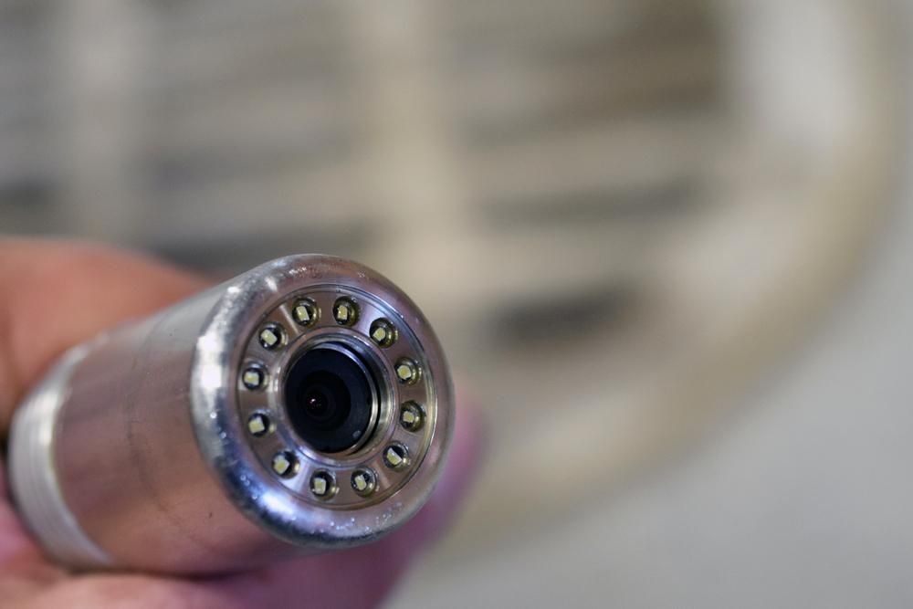 A Person is Holding a Camera in Their Hand — Affordable Plumbing In Port Macquarie, NSW