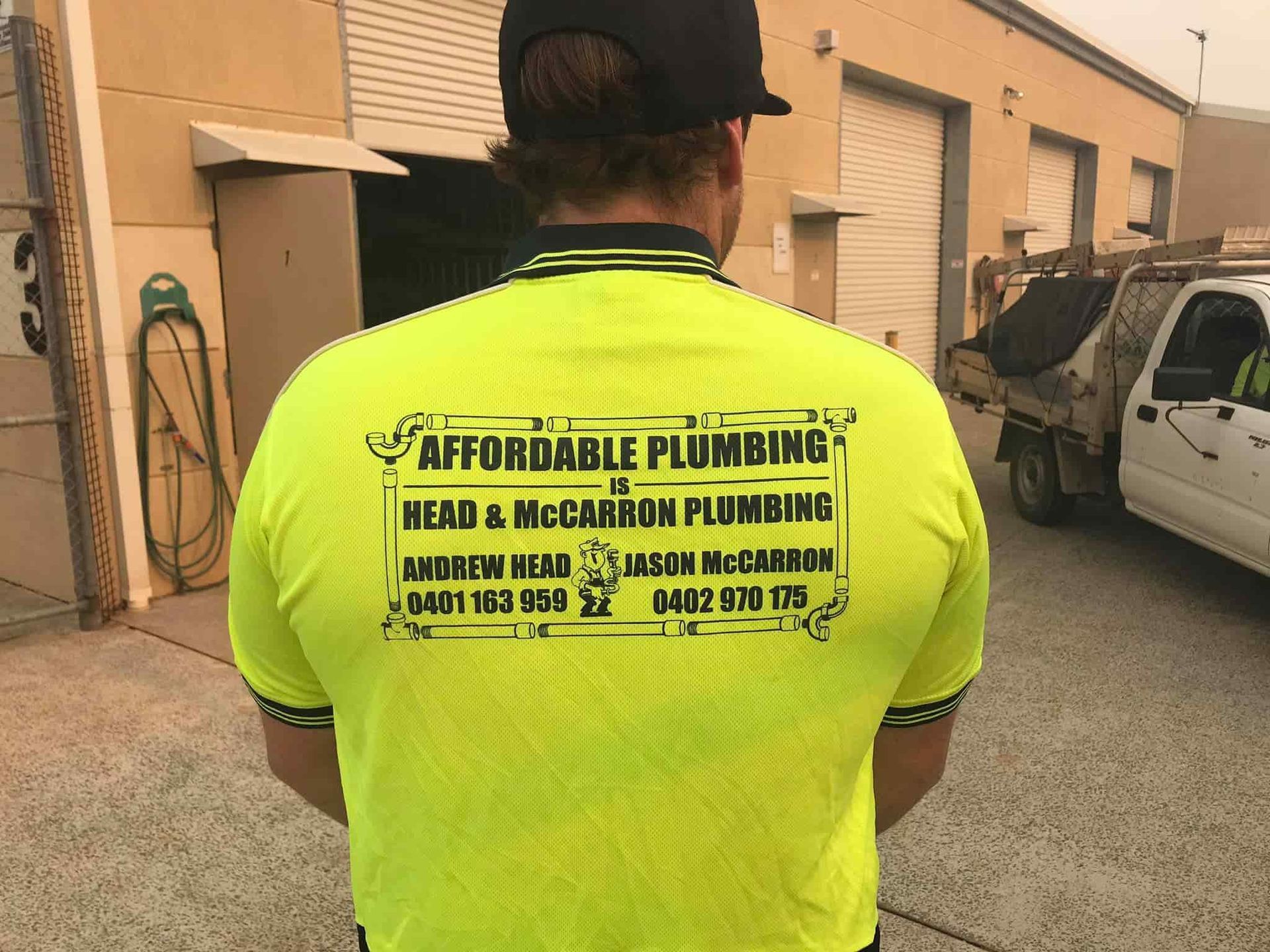 A Man Wearing a Yellow Shirt That Says Affordable Plumbing — Affordable Plumbing In Port Macquarie, NSW